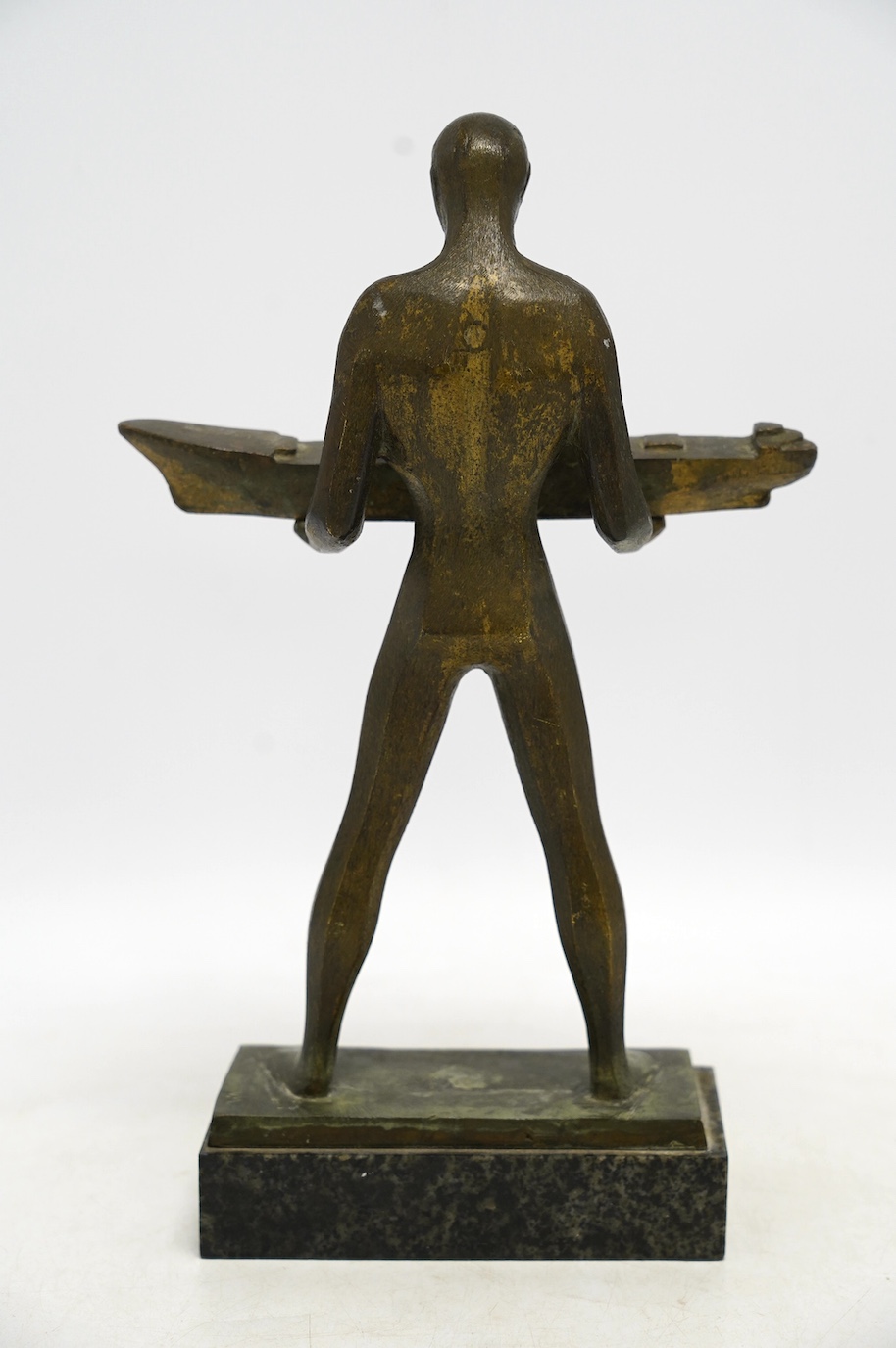 A 1960s modernist bronze figure of a man holding a boat, plaque inscribed ‘“3.MAJ” SHIPYARD AND DIESEL ENGINE FACTORY 1968.’, 29cm. Condition - fair to good